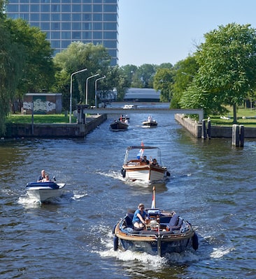 Canal cruise passes Olympic Hotel in Amsterdam.